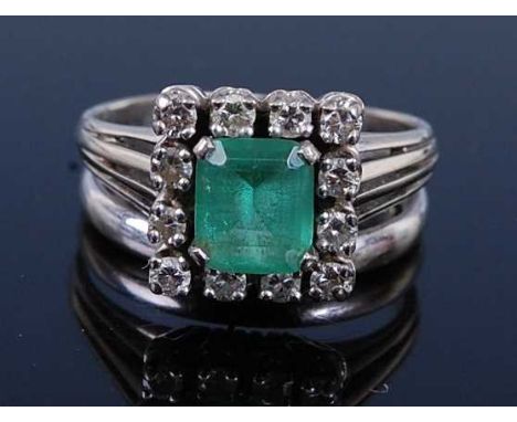 A white metal, emerald and diamond rectangular cluster ring, joined to a 3mm D-shaped wedding band, comprising a rectangular 