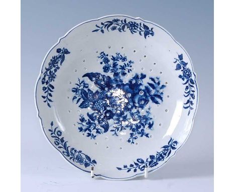 An 18th century Worcester porcelain cheese strainer, blue and white printed in the pinecone pattern, crescent mark verso, 23c