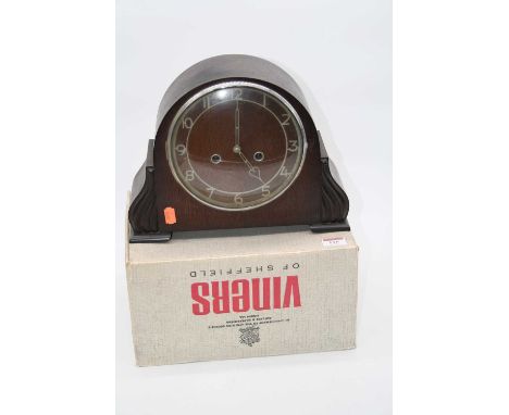 A 1950s oak cased mantel clock having raised Arabic numerals and 8-day chiming movement