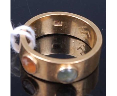 A yellow metal and semi-precious set band ring, with Swastika engraved to inside of band, indistinctly marked, 7.3g; together