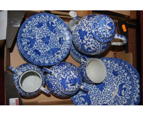 A Japanese blue and white tea service, decorated with birds amidst flowers and foliage