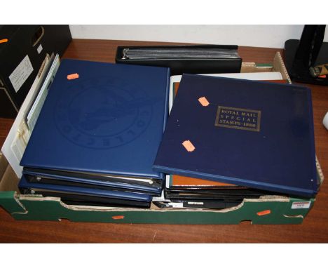 A box of vintage stamps and first day covers, mainly housed in albums