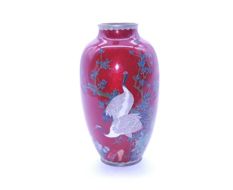 An early 20th century Japanese cloisonne vase, of baluster form, on a red ground enamel decorated with birds amidst flowers a