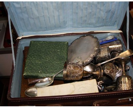 A brown leather case and contents to include silver plated goblets, silver plated card waiter, cased and loose flatware etc.