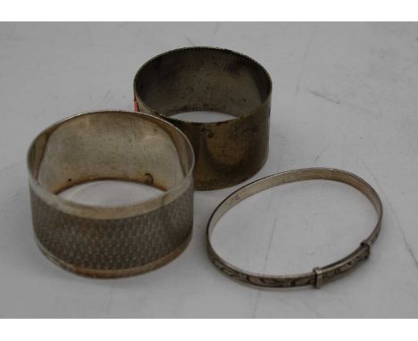 A George V silver napkin ring, Birmingham 1915; together with one other; and a white metal bangle (3) gross 1.9oz 