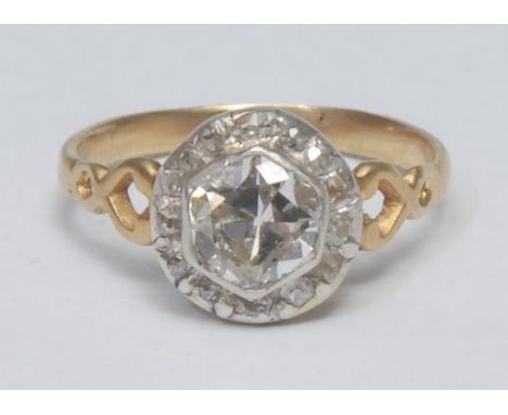 A diamond cluster ring, central hexagonal cut diamond approx 1.10ct, collar set above a surrounding band of fourteen old and 