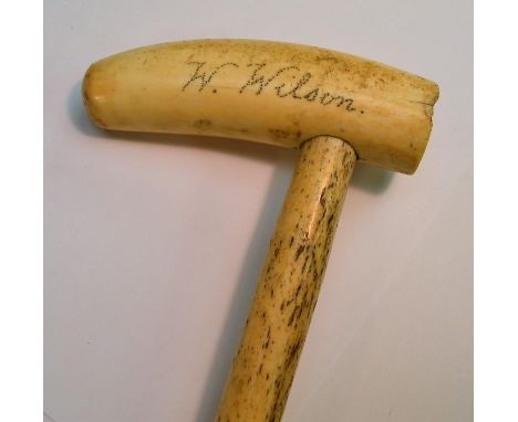 An early 19th century sailor's folk art whale bone walking stick, the scrimshaw tooth handle inscribed W Wilson, Lindisfarne 