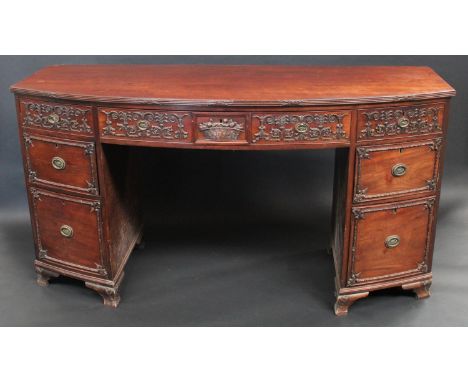 A 19th century mahogany bow fronted sideboard, in the Chippendale Rococo taste, slightly oversailing top with ribbon-wrapped 