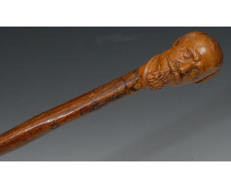 A 19th century Folk Art stick, carved with a Dickensian gentleman,  92.5cm long