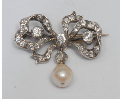 A late 19th/early 20th century diamond and pearl ribbon bow brooch, tied bow white metal frame inset with forty old mixed cut