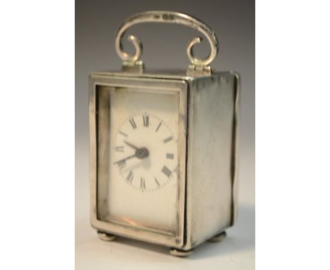 An Edwardian silver carriage timepiece, 4cm rectangular enamel clock dial, Roman numerals, eight-day movement, the case with 