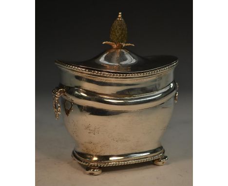 A George V silver rounded rectangular tea caddy, hinged cover with pineapple finial, gadrooned borders, handles to sides, bun