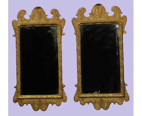 A pair of George II style giltwood Vauxhall looking glasses, shaped crestings, borders and aprons carved with acanthus, bevel