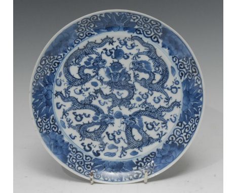 A Chinese circular plate, painted in tones of underglaze blue with dragons chasing the flaming pearl, 20cm diam, 19th century