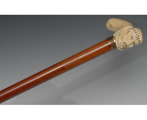 A 19th century walking stick, the ivory haft carved with a gentleman wearing a nightcap, malacca shaft, 80cm long