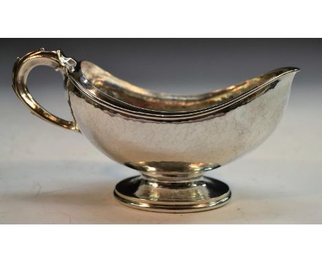 Omar Ramsden - an Arts and Crafts silver boat shaped pedestal sugar basin, domed foot, scroll handle, 14.5cm wide, London 193