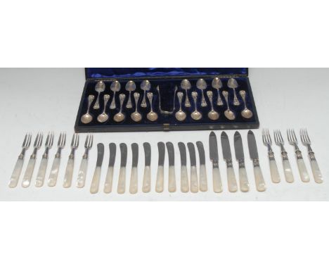 A set of eighteen Victorian silver teaspoons, embossed and engraved in the Rococo taste with shells and acanthus, sugar bows 