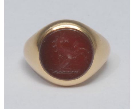 A lady's 18ct gold and carnelian armorial signet ring, the circular matrix engraved intaglio with the Severn family crest, of