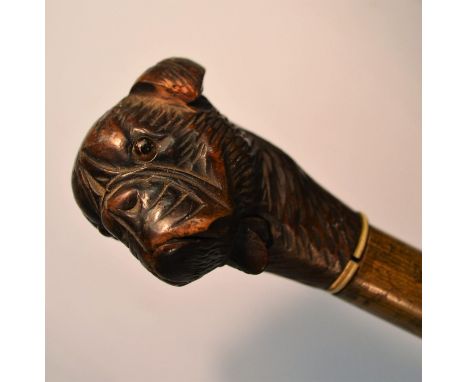 A Black Forest novelty automaton walking cane, the pommel carved as the head of a dog, articulated mouth, 93cm long, c.1900
