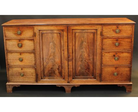 A George III mahogany low housekeeper's or press cupboard, in the manner of Gillows, rectangular top with moulded edge above 