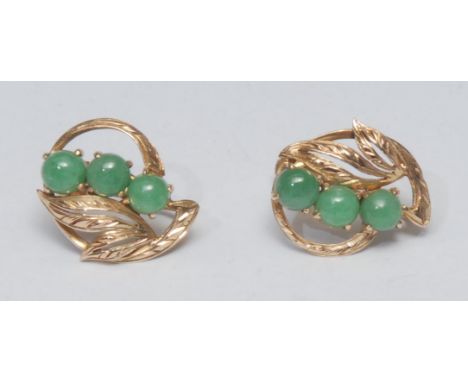 A pair of screw back leaf earrings, inset with three green stone round cabochons possibly jade, 14ct gold mounts, stamped 14k
