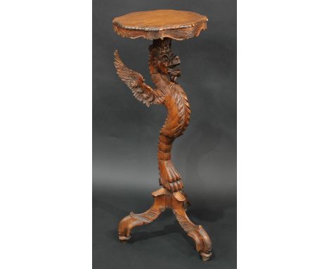 A Venetian limewood tripod torchere, boldly carved as a dragon monopodia, shaped serpentine plateau, scroll feet, 95cm high, 
