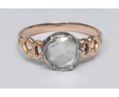 An early 19th century rose cut diamond solitaire ring, irregular rose cut round diamond approx 0.54ct, white metal collar set