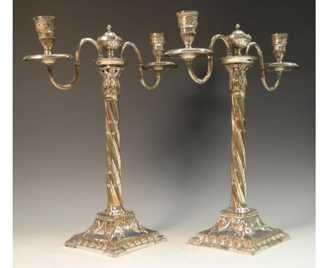 A pair of George III Neo-Classical Old Sheffield Plate two-light, two-branch table candelabra, urnular finials, spiral cluste