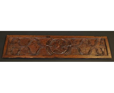 A 16th/17th century oak rectangular panel, carved with a portrait roundel, 106.5cm wide