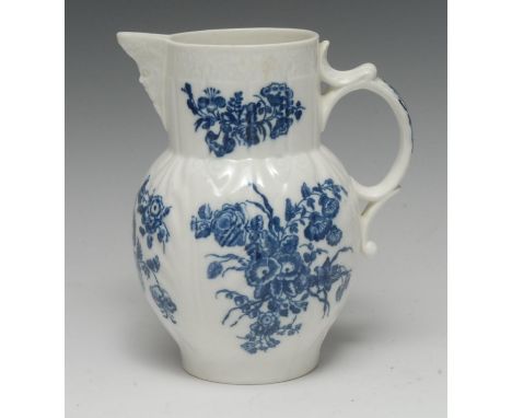 A Caughley cabbage leaf moulded mask jug, printed in underglaze blue with flower sprays, C-scroll handle, 19cm high, c.1770