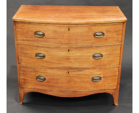 A George III mahogany bow fronted chest, of three long graduated cockbeaded drawers, crossbanded top outlined with boxwood st