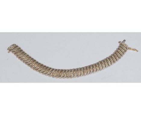 A contemporary diamond wave panel tennis bracelet, encrusted with three hundred and eighty seven round brilliant cut diamonds
