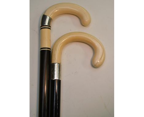 A George V gentleman's silver-mounted ivory and ebony walking stick, crook-shaped handle, monogrammed silver collar, tapering