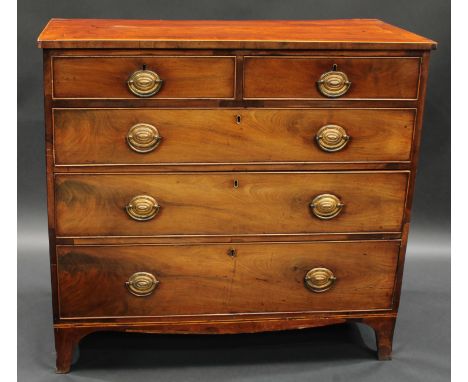 A George III mahogany chest, crossbanded top, two short cockbeaded drawers over three graduated long, oval brass escutcheons,