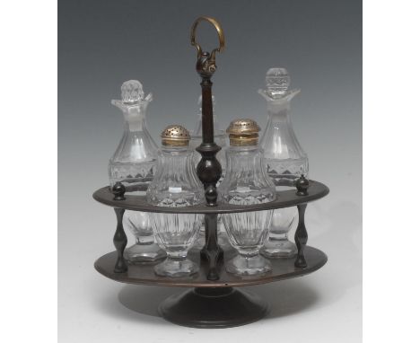 A George IV mahogany five-bottle oval cruet stand, turned pillars, posted central column with axe head handle, the facetted b