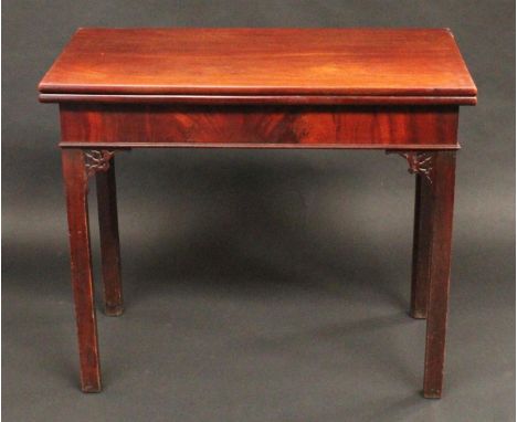 A George III mahogany rectangular tea table, in the provincial Gothic Chippendale taste, folding top above a deep frieze, and