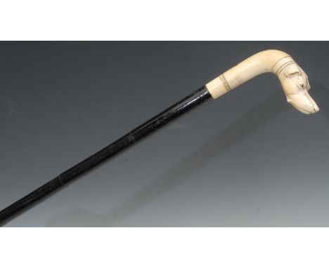 A 19th century walking stick, the ivory handle carved with a greyhound, inscribed From G.G.P., segmented ebonised shaft, 92cm