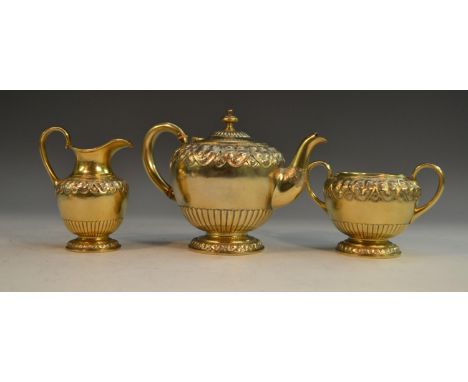 A Victorian silver-gilt bachelor's tea service, comprising bullet shaped teapot, milk jug and sugar basin, each half-fluted a