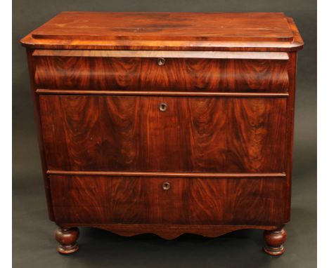 A 19th century German 'Biedermeier' flame mahogany chest, caddy top above three drawers, turned forefeet, 88cm high, 96cm wid