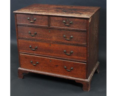A George III oak chest, slightly oversailing top above two short and three long graduated cockbeaded drawers, brass swan neck