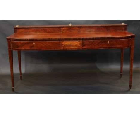 A George III mahogany break-centre bow fronted sideboard, shallow superstructure, the projecting base with a pair of frieze d