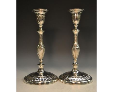 A pair of Adam Revival silver table candlesticks, detachable sconces, baluster pillars, circular bases, sunflower petal borde