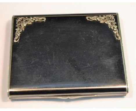 A Continental Art Deco silver and noir enamel rectangular vanity case, hinged cover applied with marcasite spandrels, enclosi