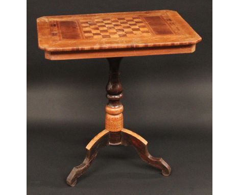 A 19th century Italian marquetry canted rectangular pedestal games table, inlaid for chess within a parquetry border, turned 