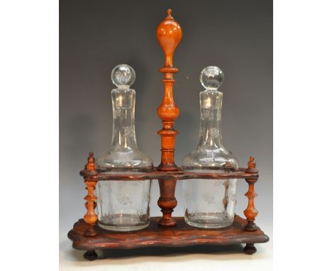 A 19th century French rosewood shaped rectangular two-bottle decanter stand, turned posted handle, the mallet shaped decanter