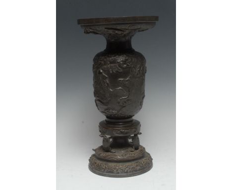 A Japanese dark-patinated bronze ikebana vase, the baluster cast in alternating relief with traditional figures of the shogun