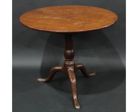 A George III mahogany tripod supper table, circular one piece top tilting on a birdcage, cabriole legs, pad feet, 73cm high, 