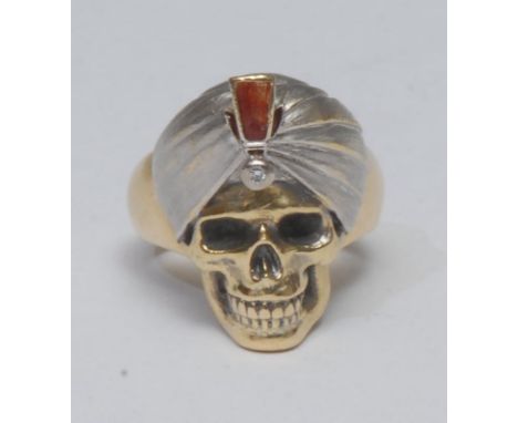 Theo Fennell - a substantial contemporary gentleman's 18ct gold memento mori ring, boldly centred by a macabre turbaned human