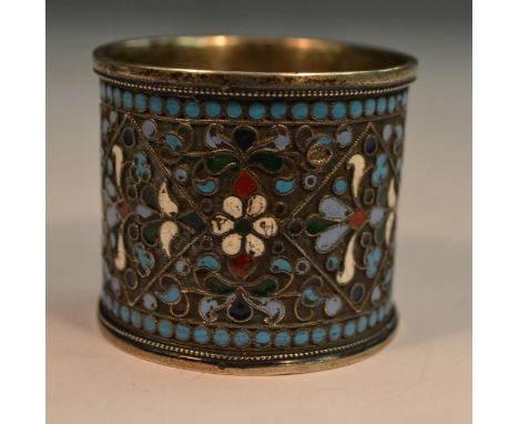 A Russian silver and cloisonne enamel napkin ring, brightly decorated in polychrome, 4cm long, c.1900