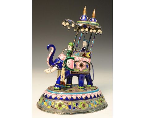 An unusual enamel and silver  model, of an elephant with howdah, coloured enamels, 19cm high